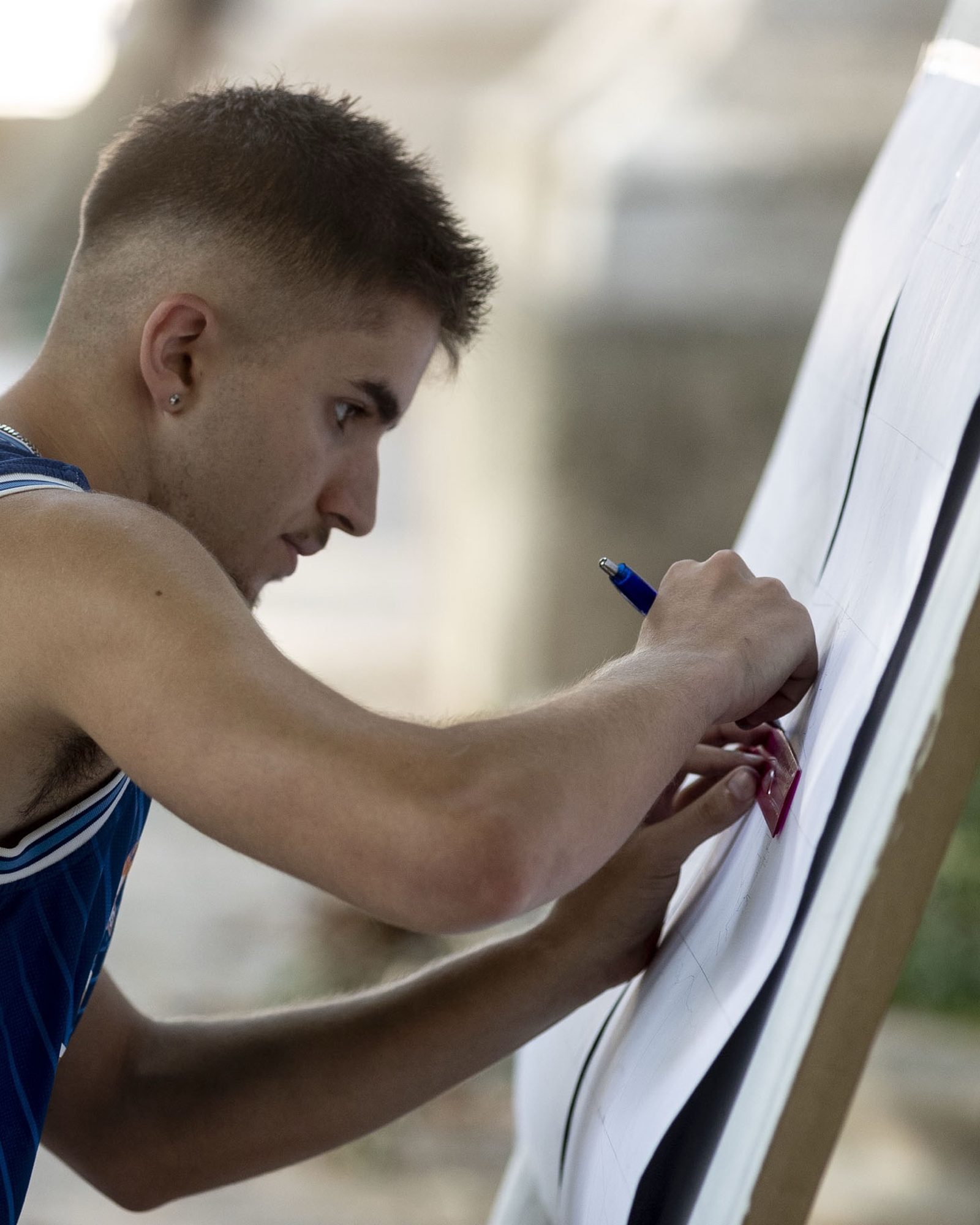Dani Delgado, mural artist, painting on site in Luxembourg