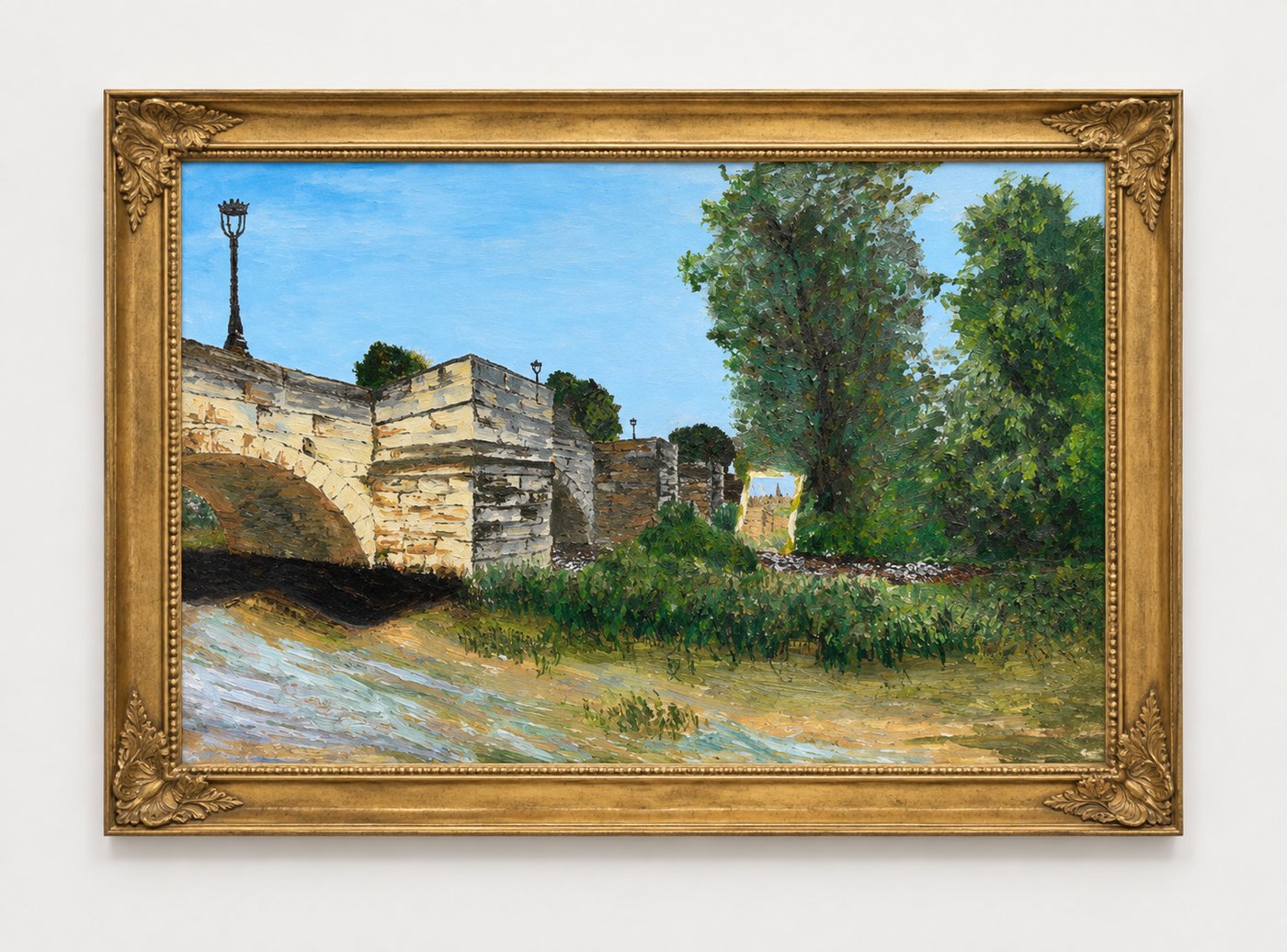 A finished landscape painting of a stone bridge, framed